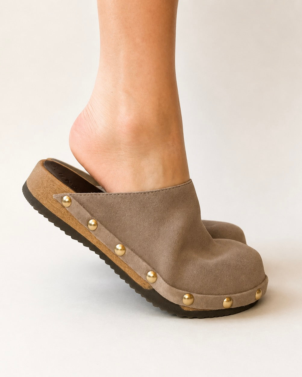 Taupe suede studded clog shoe on a white background