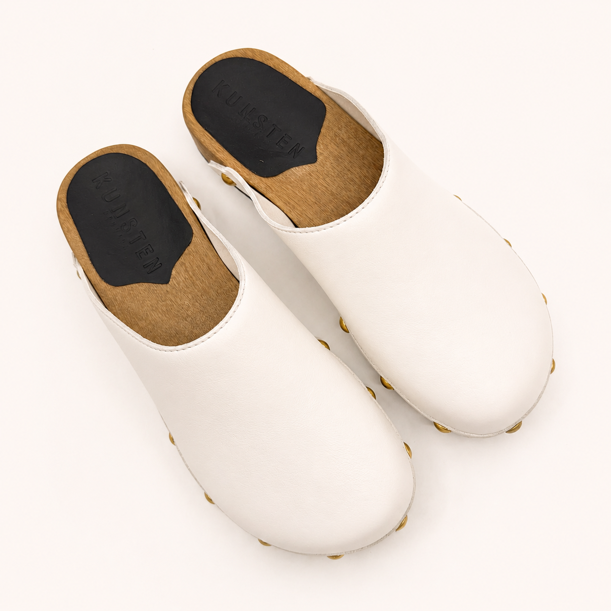 White leather studs clog shoe on a white background