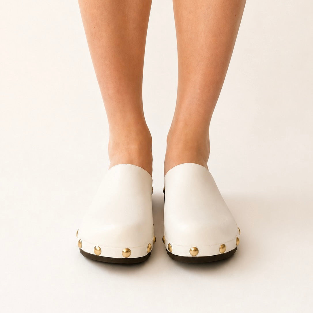 White leather studs clog shoe on a white background