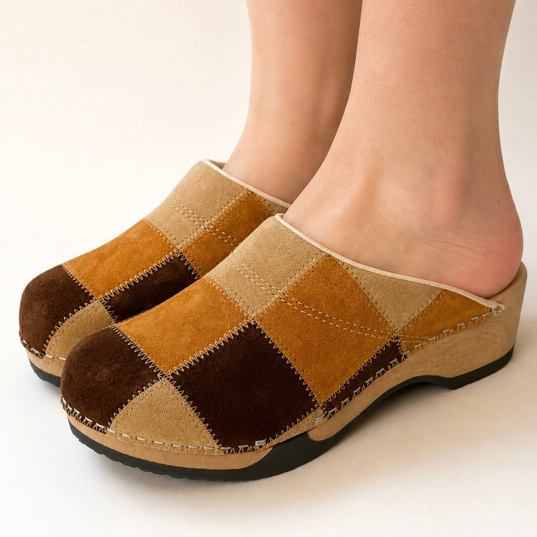 Pair of brown and beige checkered slippers on a white background