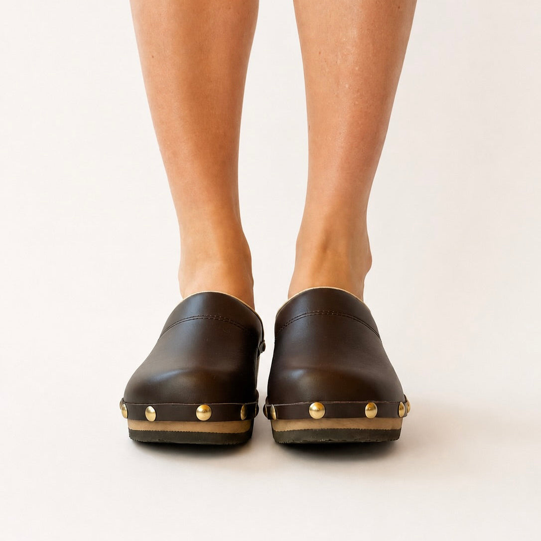 Rich brown leather studs clog shoe on a white background