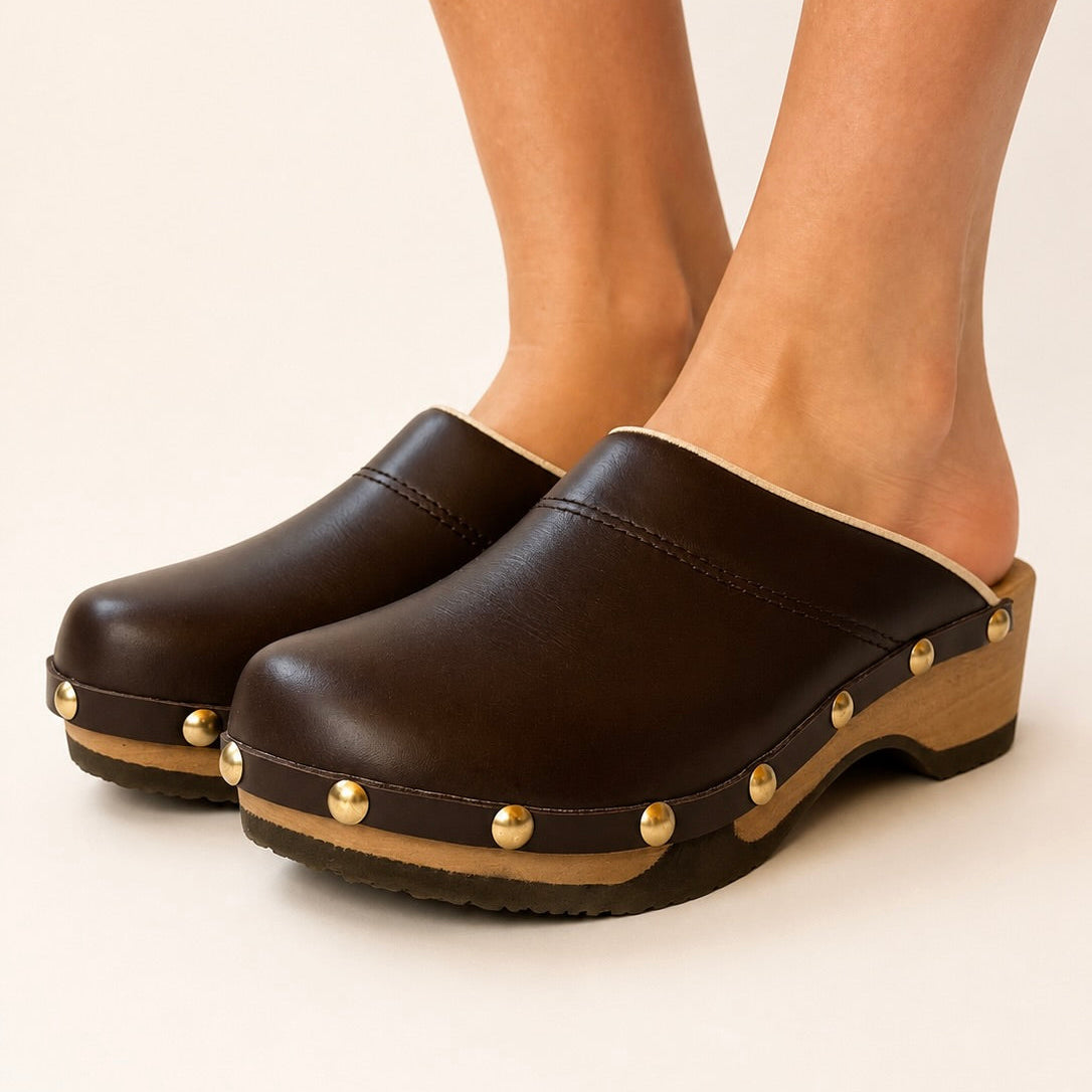 Rich brown leather studs clog shoe on a white background