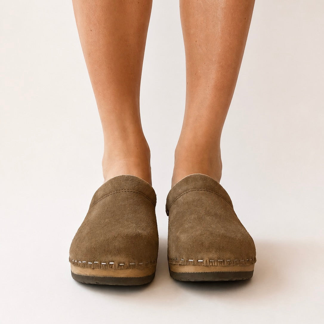 Umber suede clog shoe on a white background