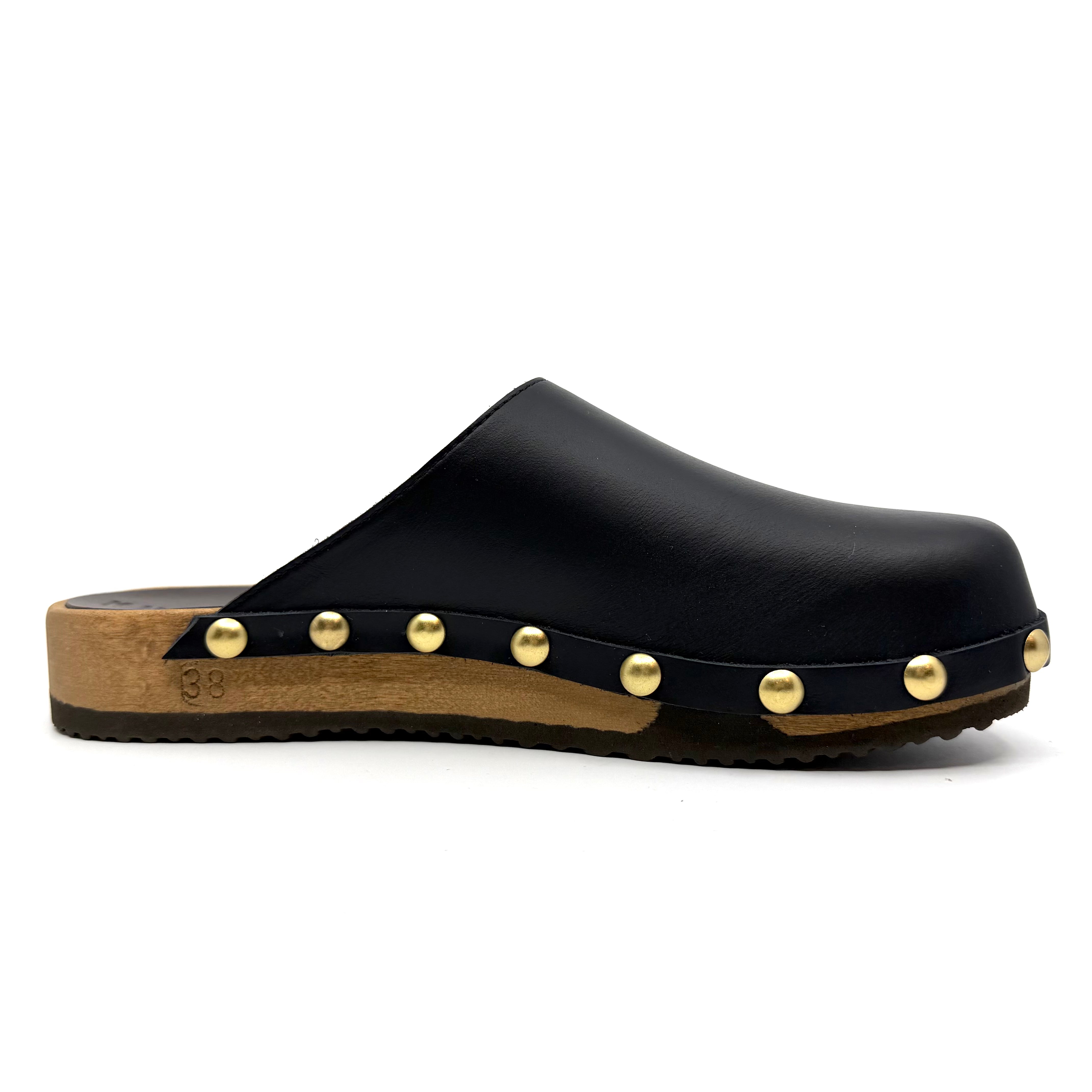 Black wooden clog shoe with gold studs on a white background