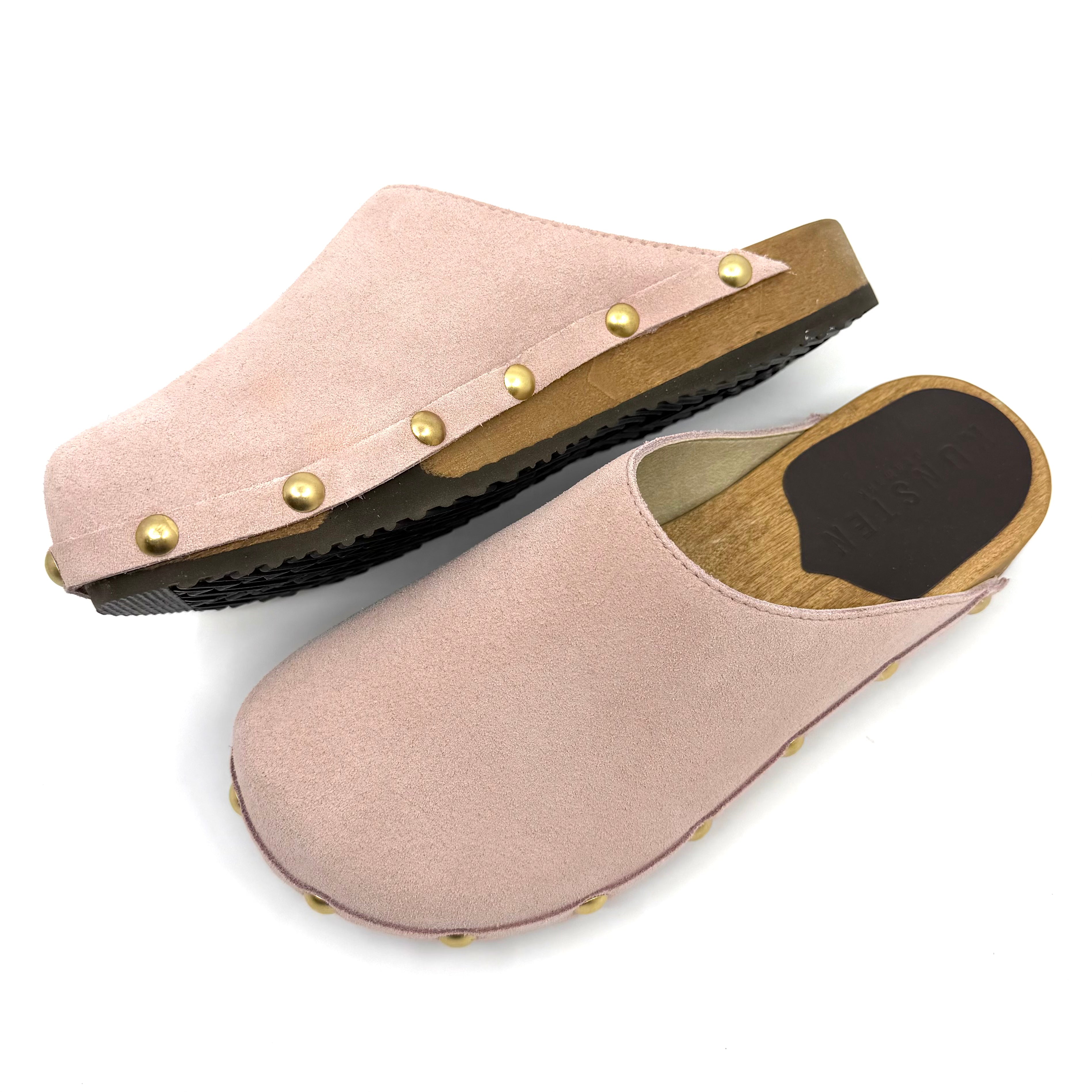 Pair of pink clogs with gold studs on a white background