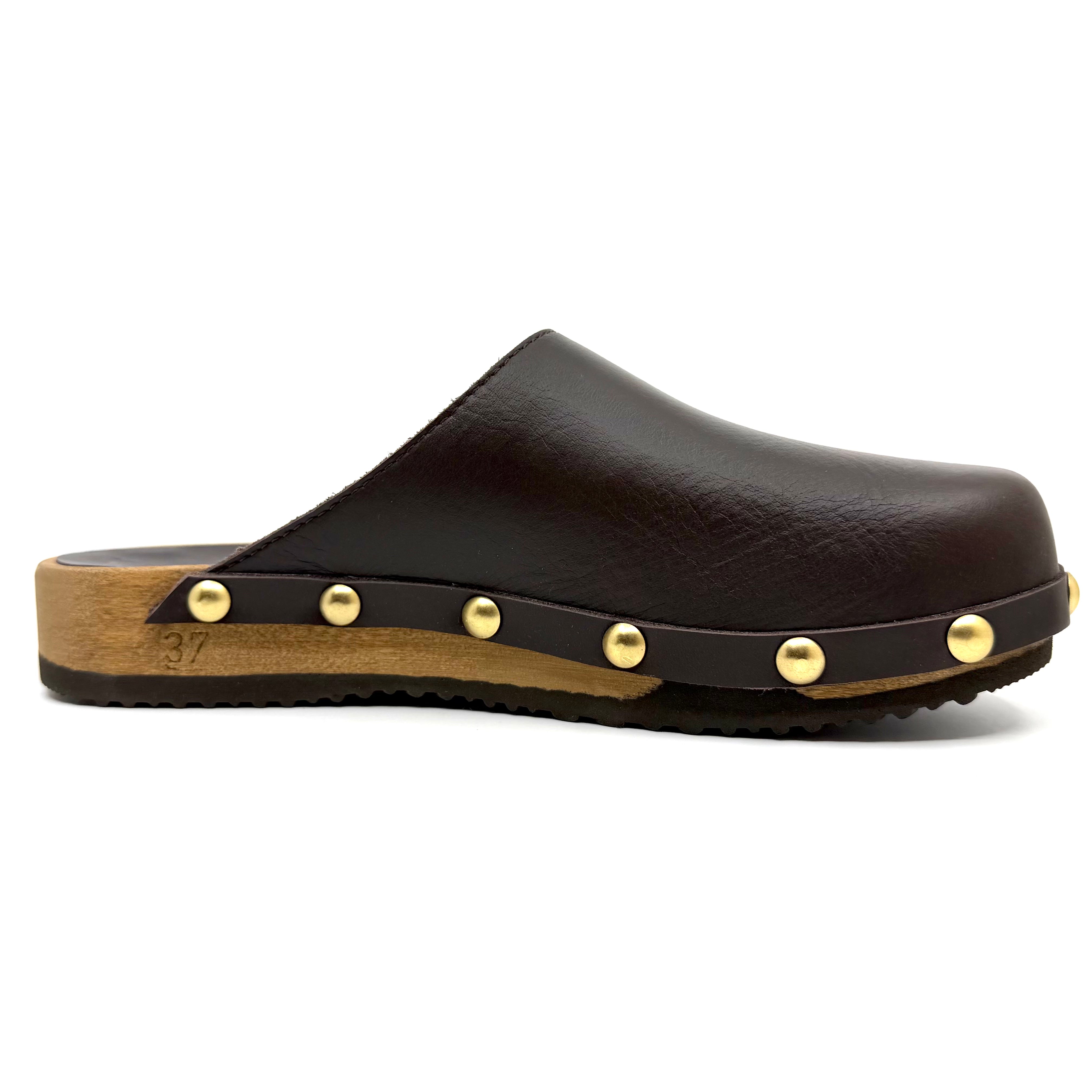 Black leather clog with wooden sole and gold studs on a white background