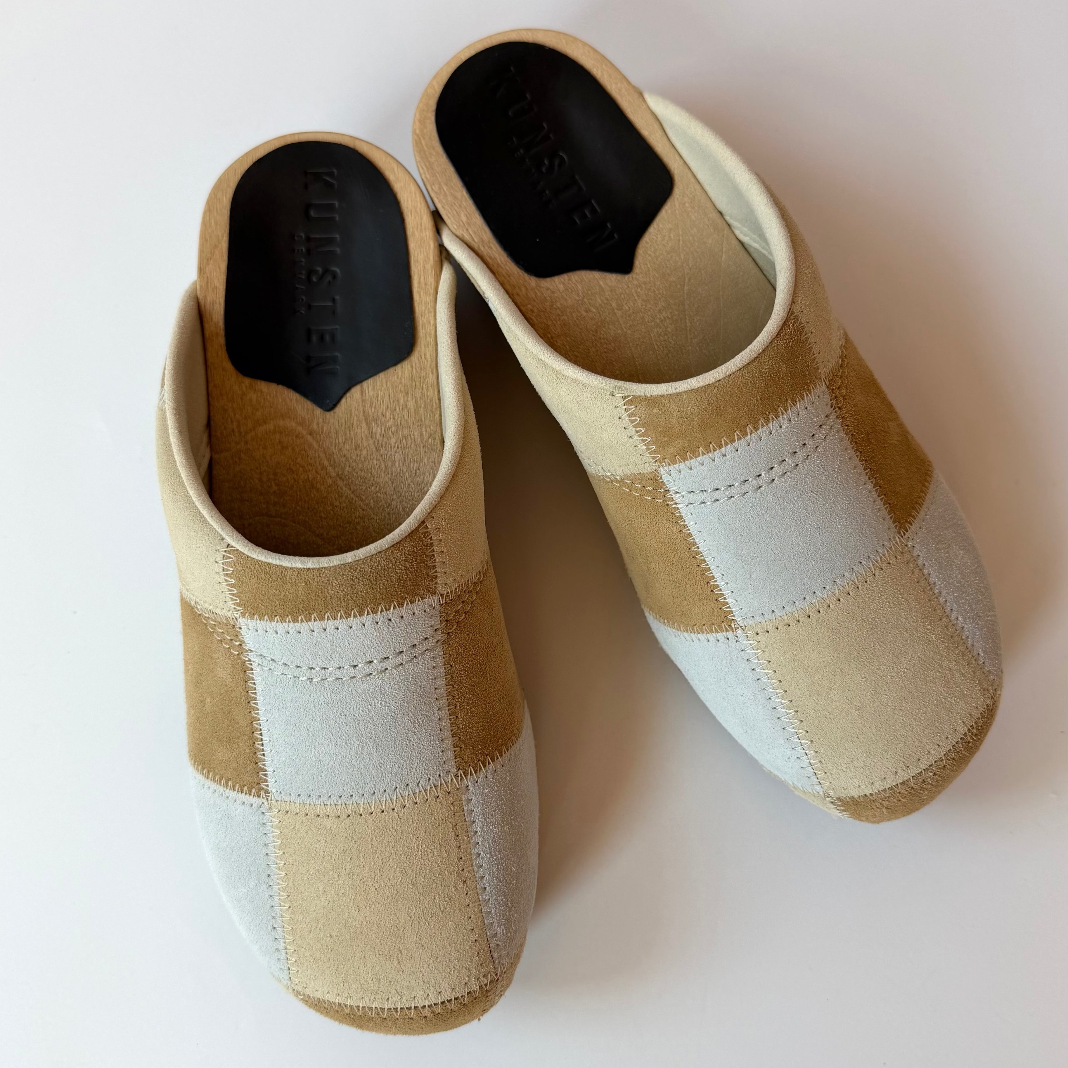 Pair of checkered slippers on a white background