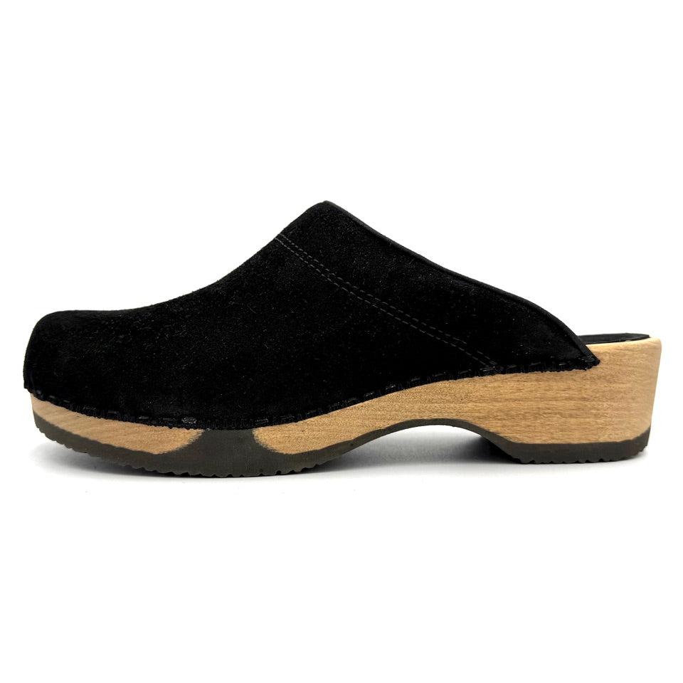 Black clog shoe with wooden sole on a white background