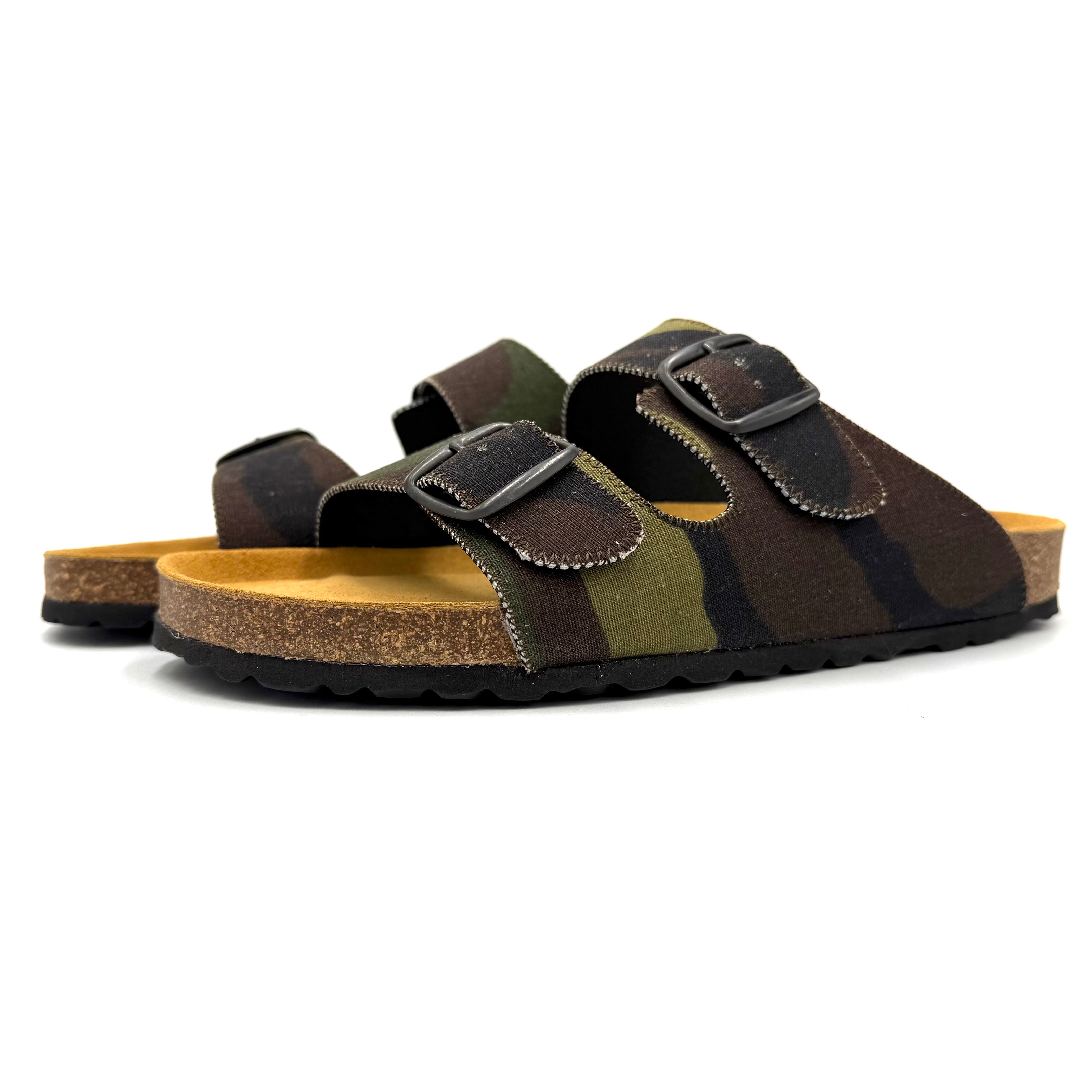 Pair of brown and green striped sandals with cork sole on a white background
