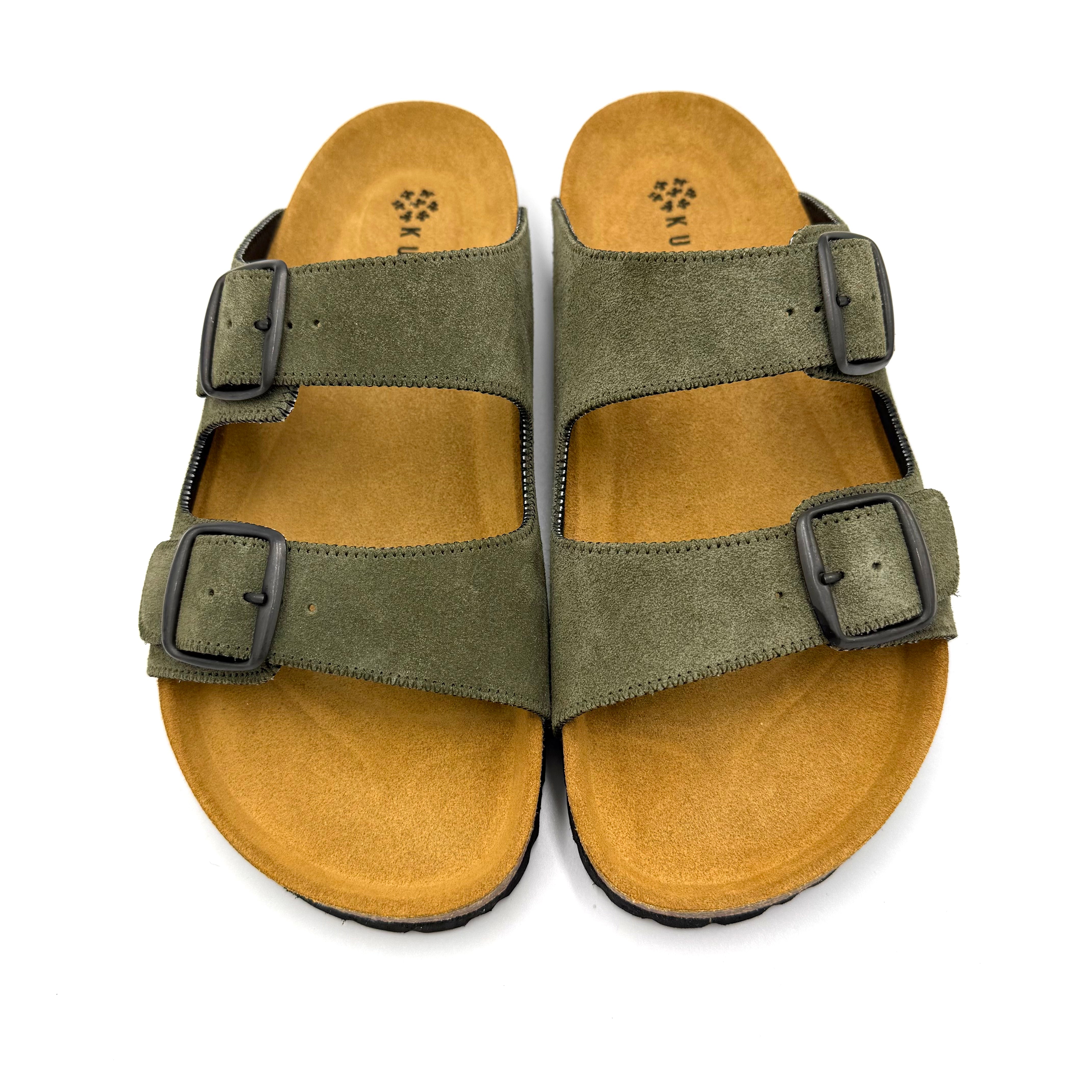 Pair of green sandals with brown soles on a white background