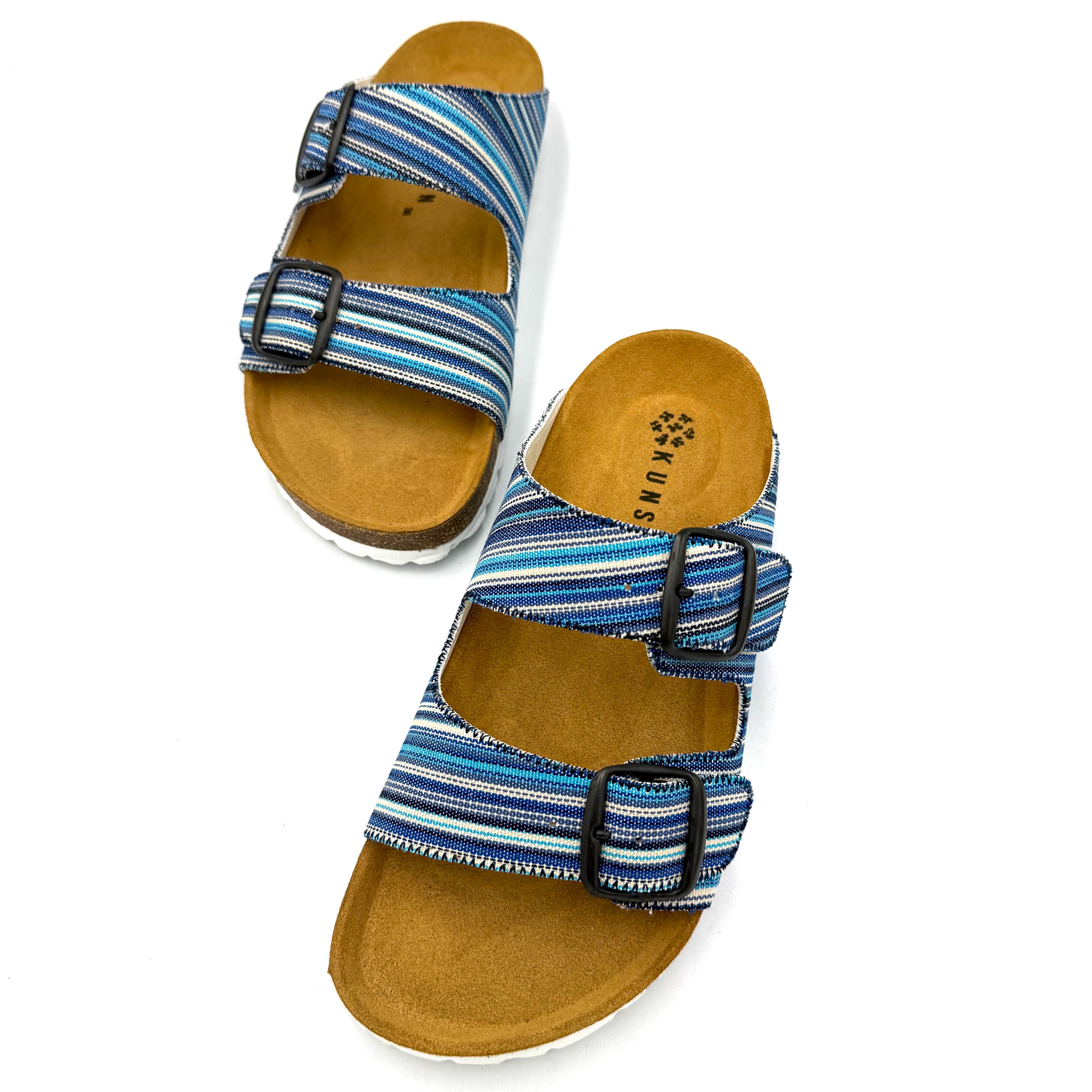 Pair of blue striped sandals with brown soles on a white background