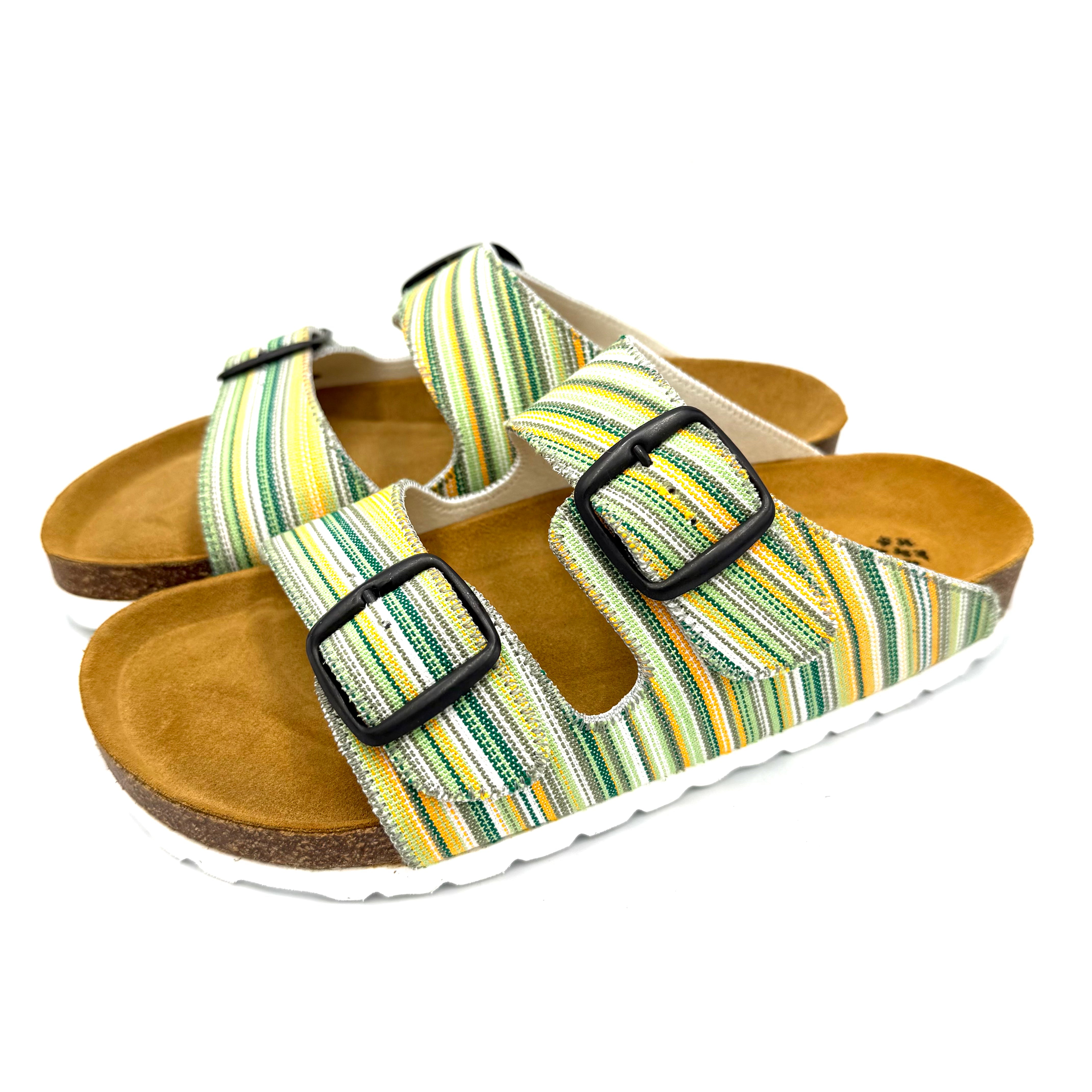 Pair of sandals with striped straps and brown soles on a white background