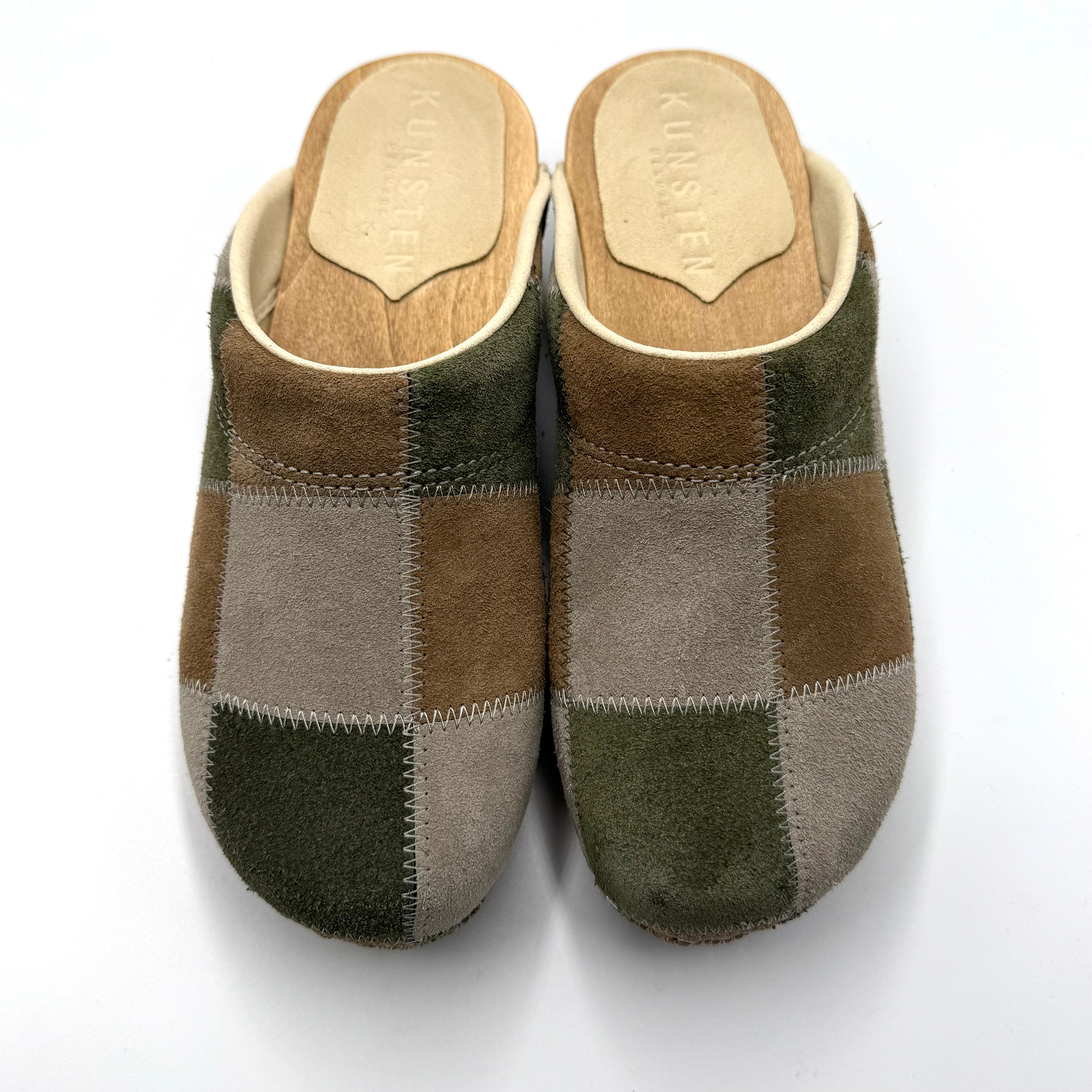 Pair of patchwork slippers on a white background