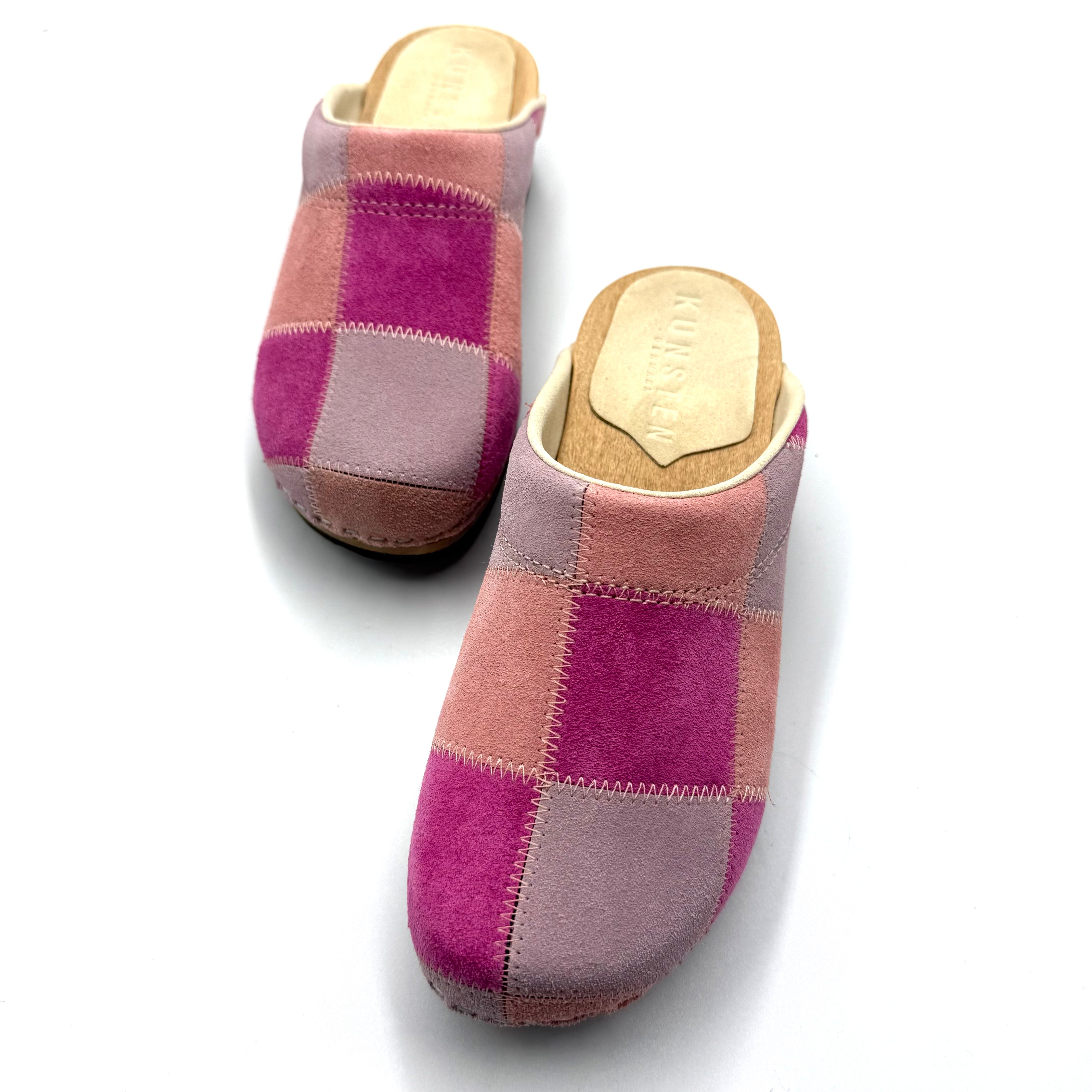 Pair of checkered clogs with wooden soles on a white background
