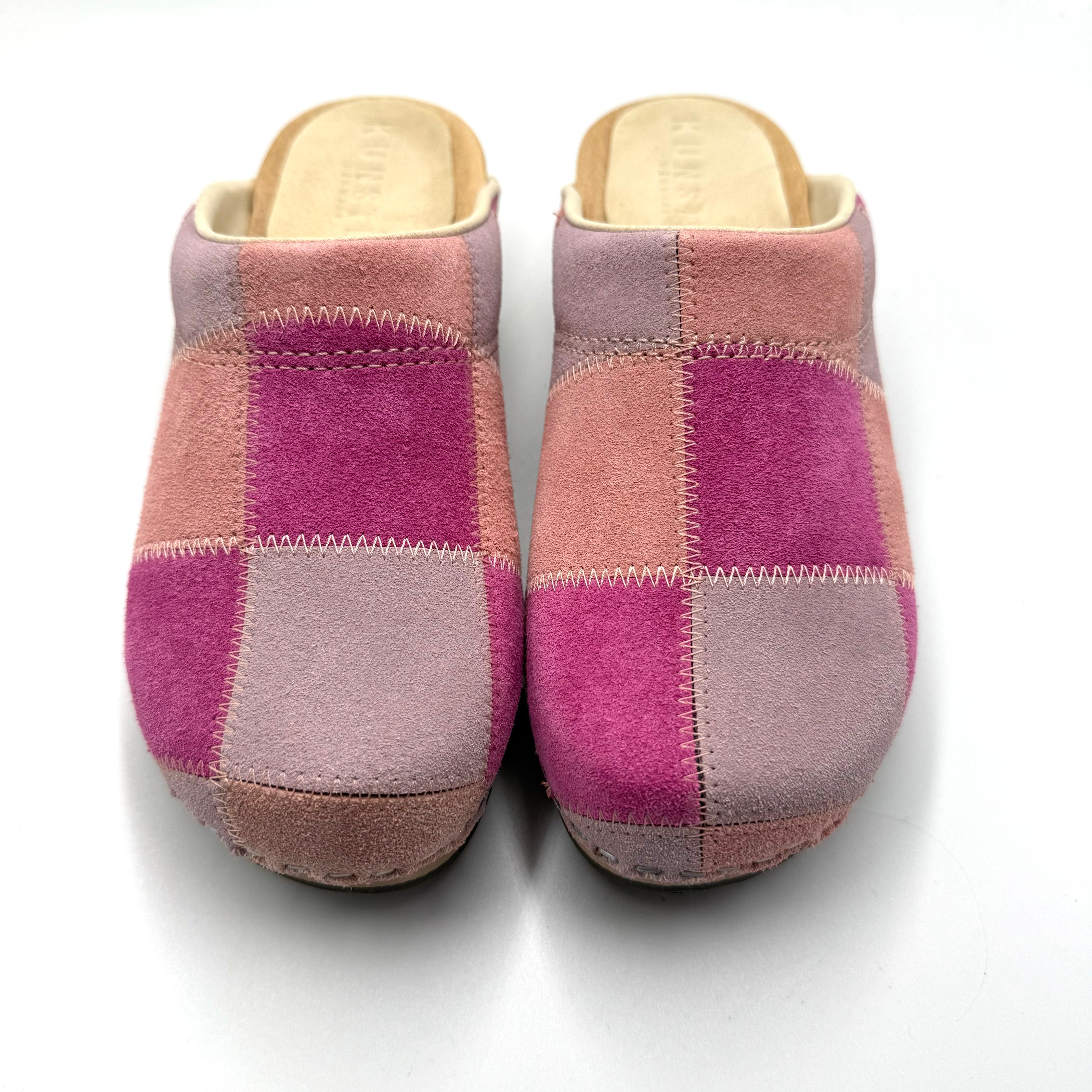 Pair of pink and purple slippers on a white background