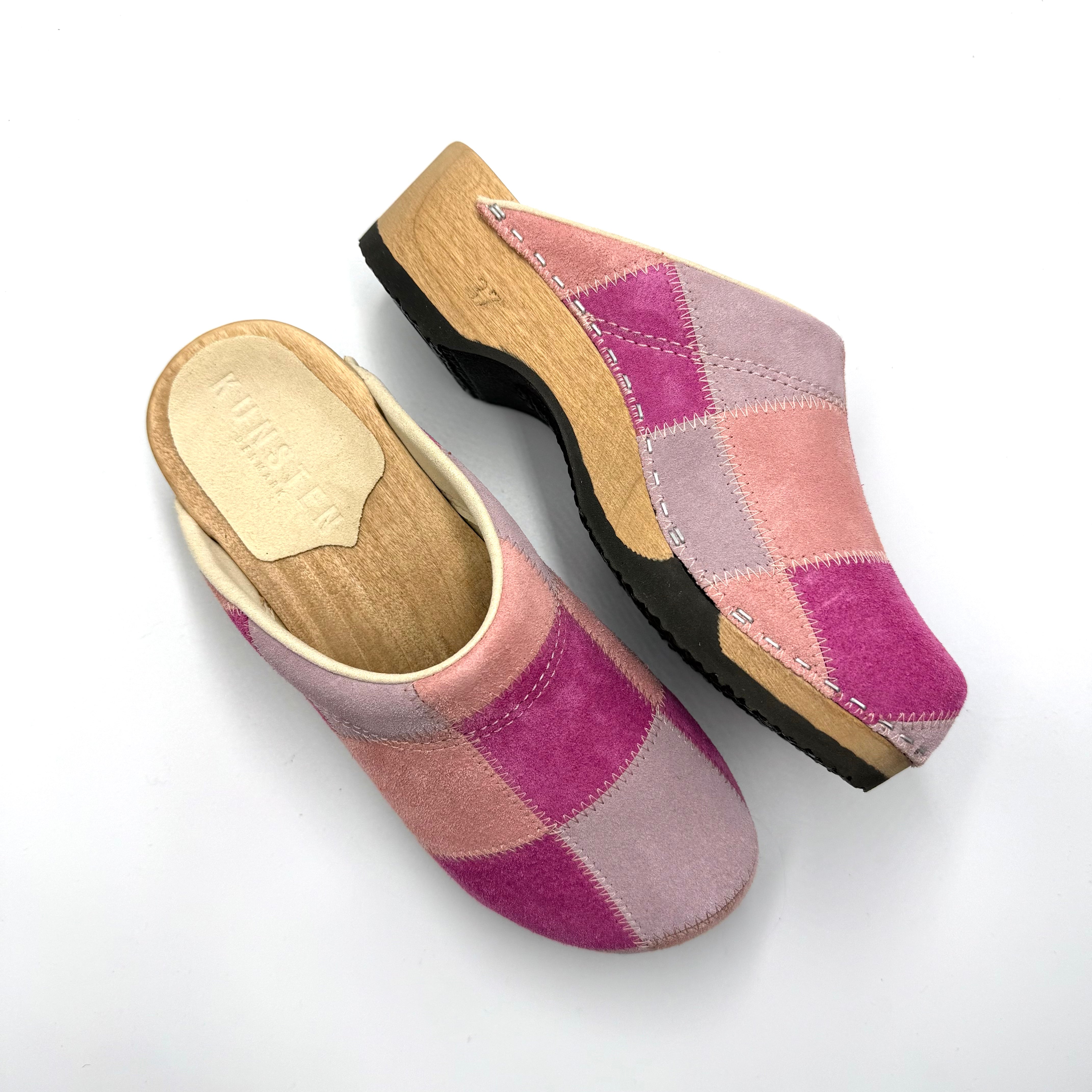Pair of pink and purple checkered clogs on a white background