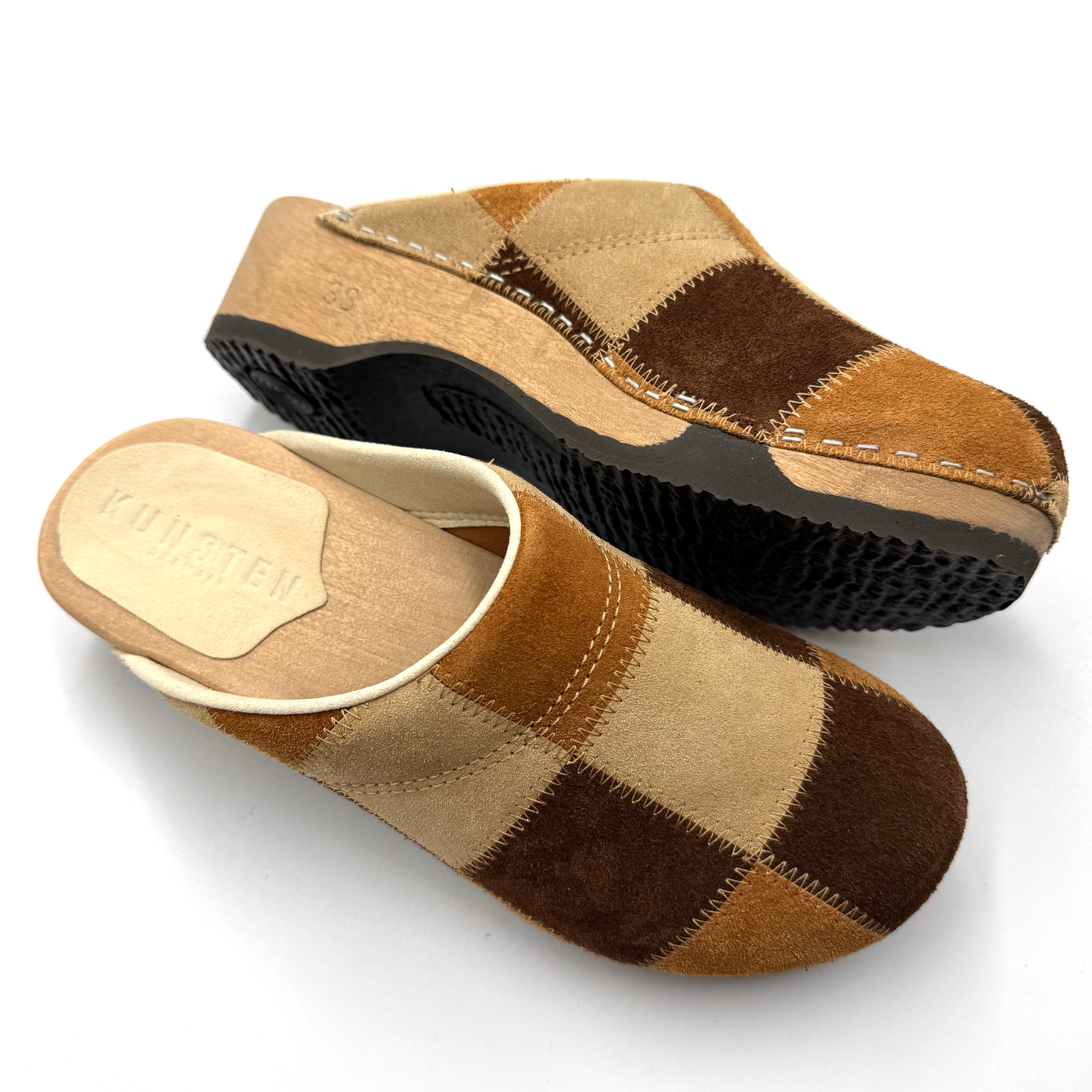 Pair of checkered clogs on a white background