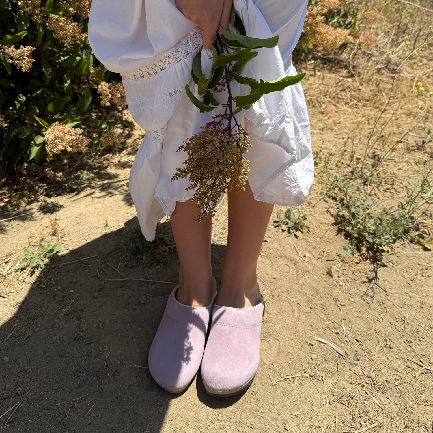 Pink clogs with wooden sole on a white background