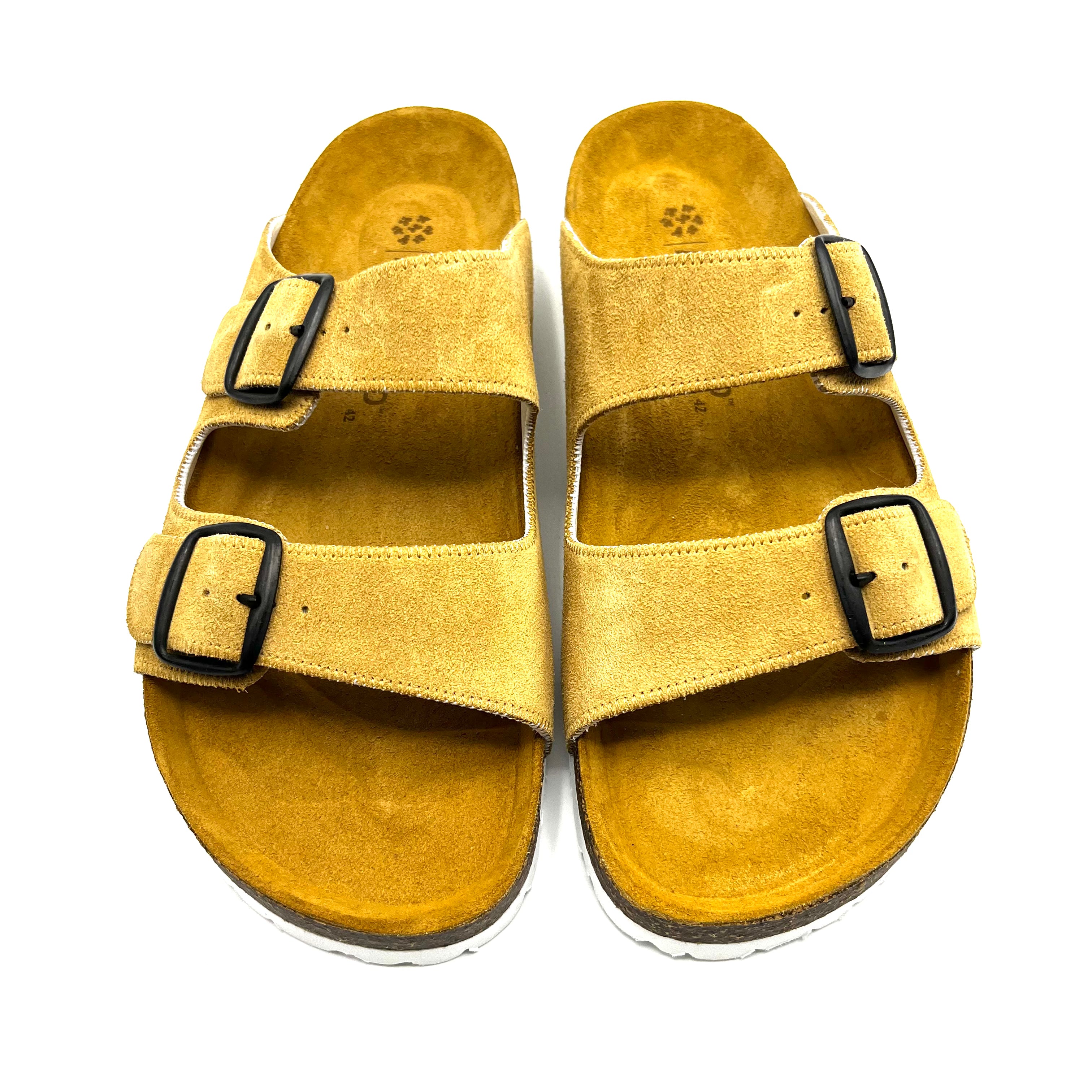 Yellow sandal with black buckles on a white background