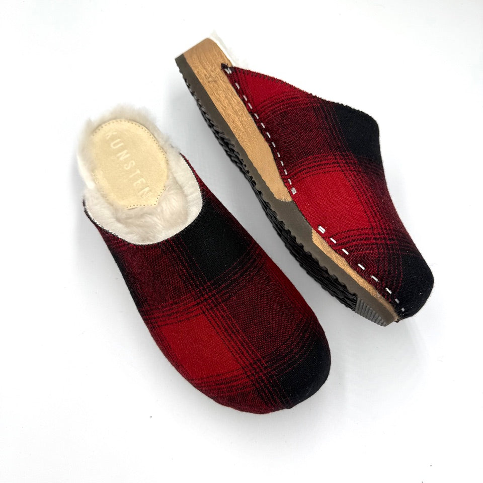 Red and black plaid slippers with wooden sole on a white background