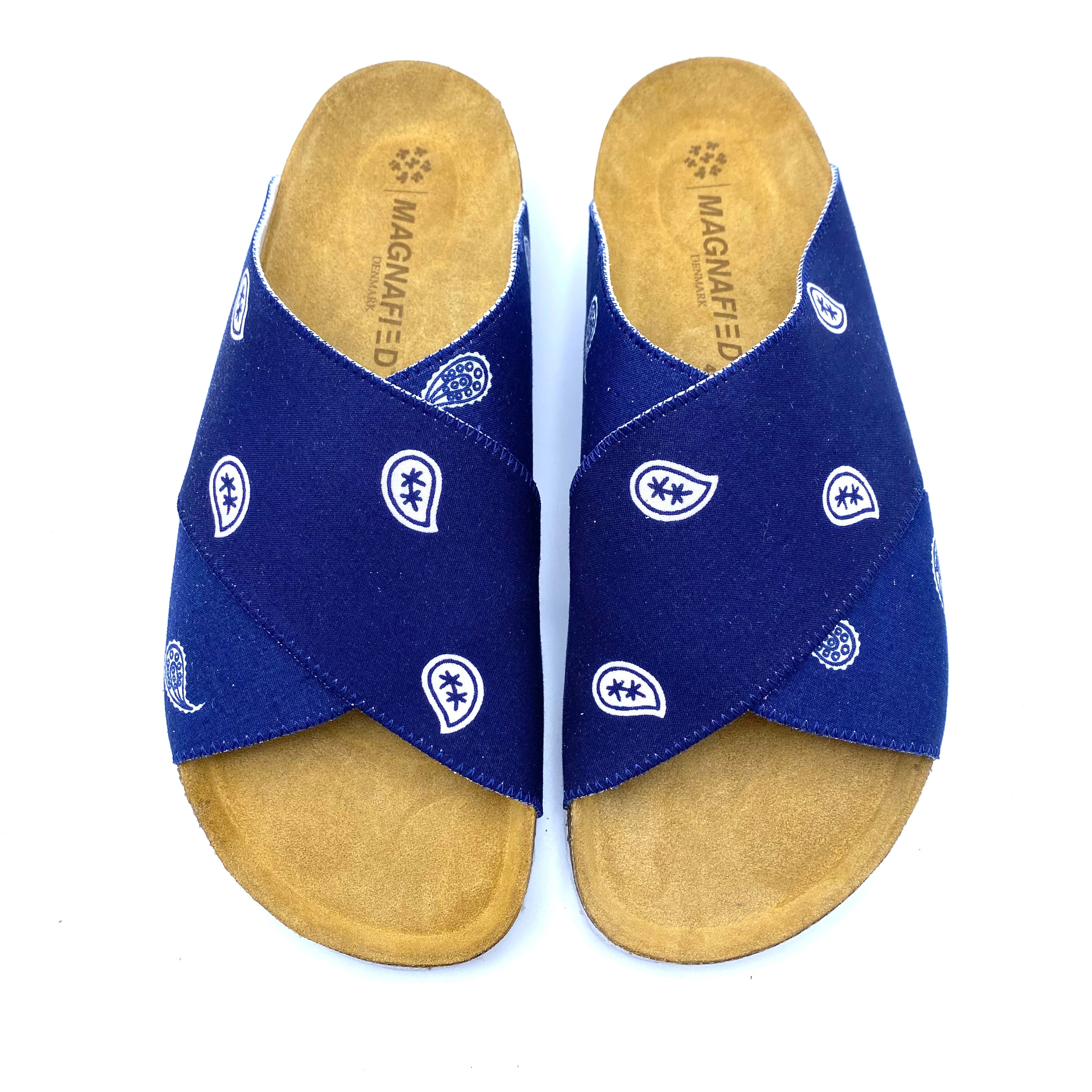 Pair of blue sandals with white patterns on a white background