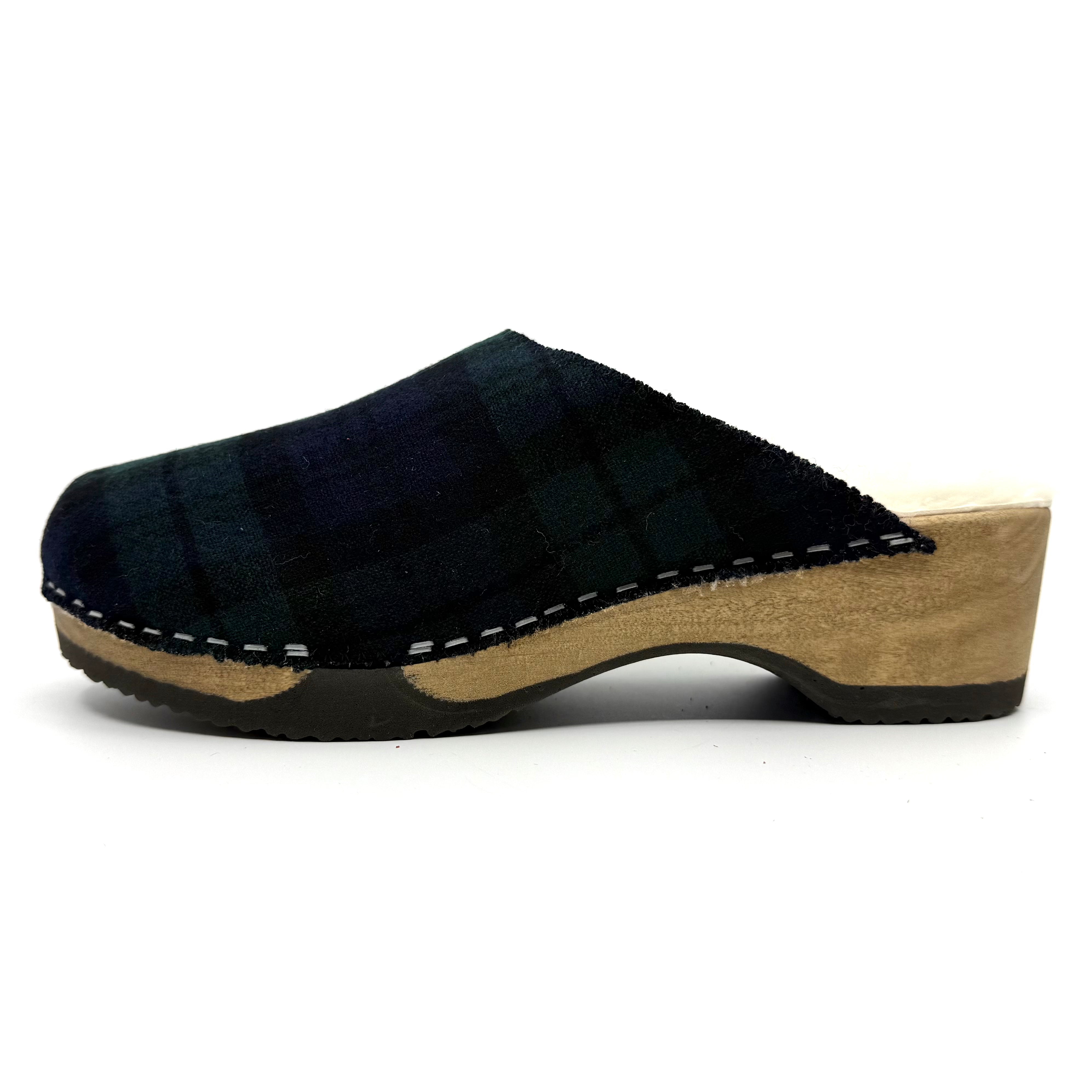 Black wooden clog shoe on a white background