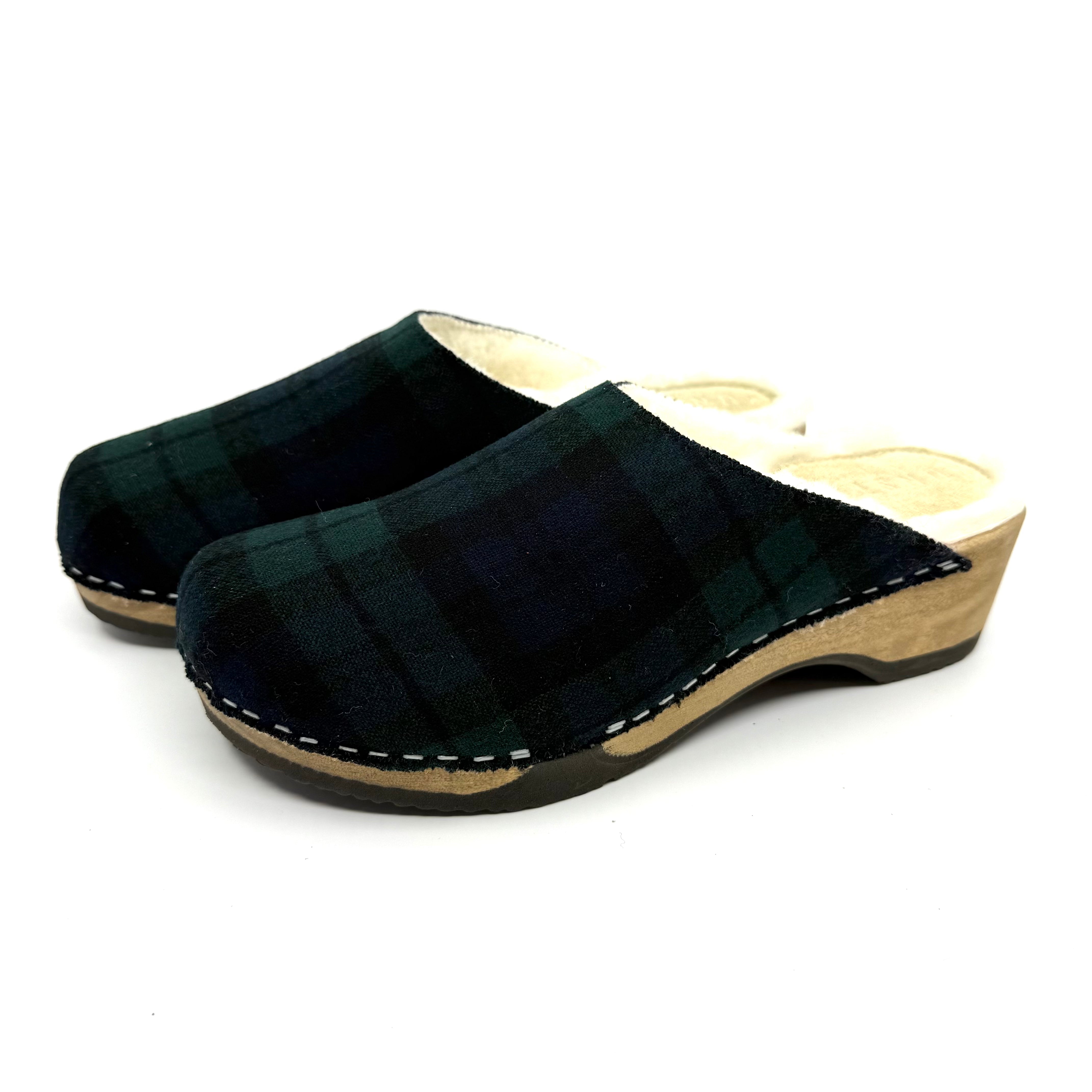 Pair of black plaid clogs on a white background