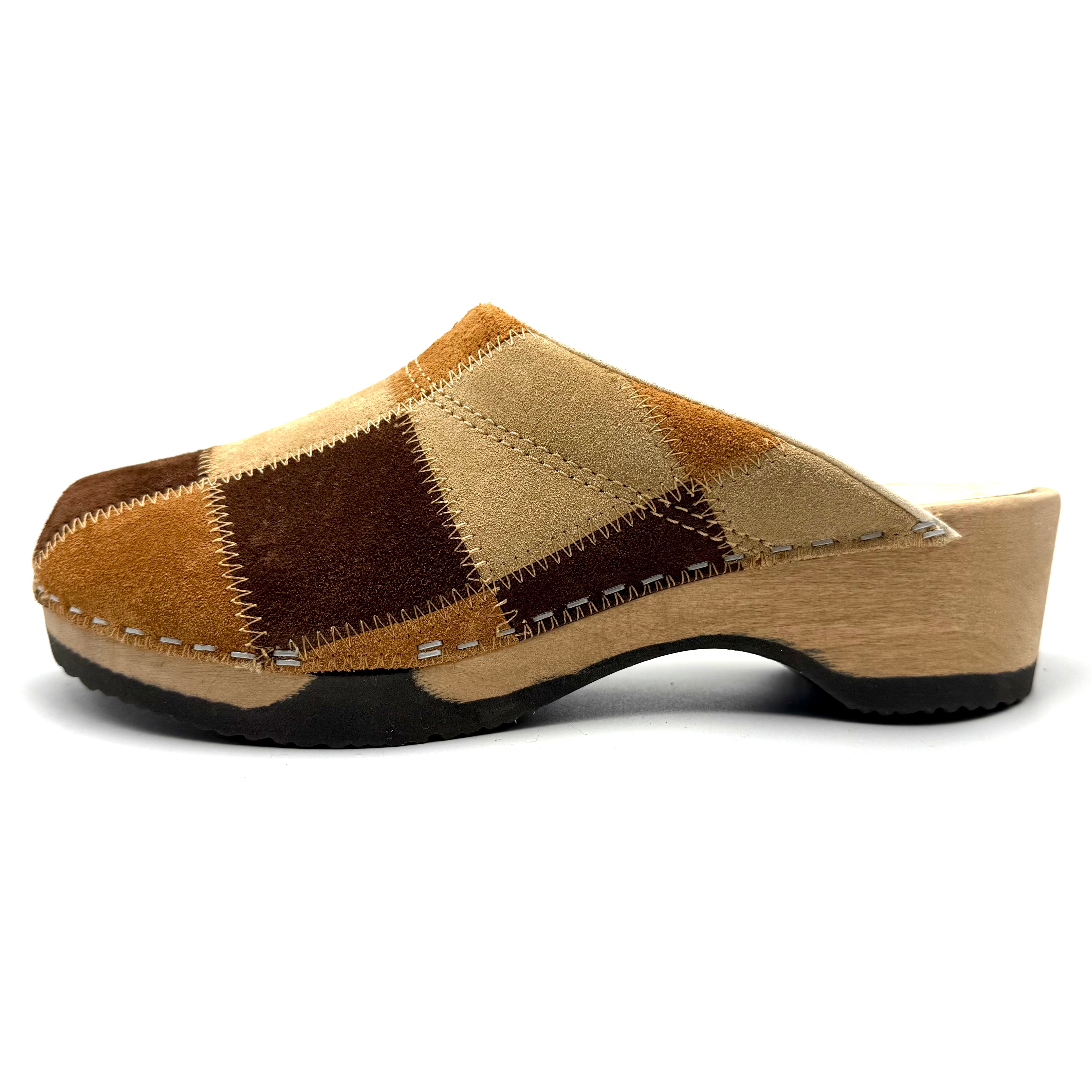 Wooden clog shoe with patchwork design on a white background