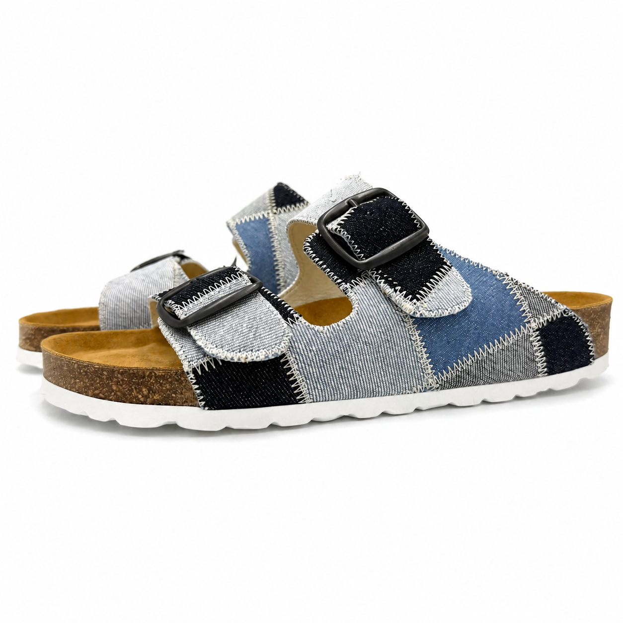 Person wearing blue and brown checkered sandals with white socks on a plain background