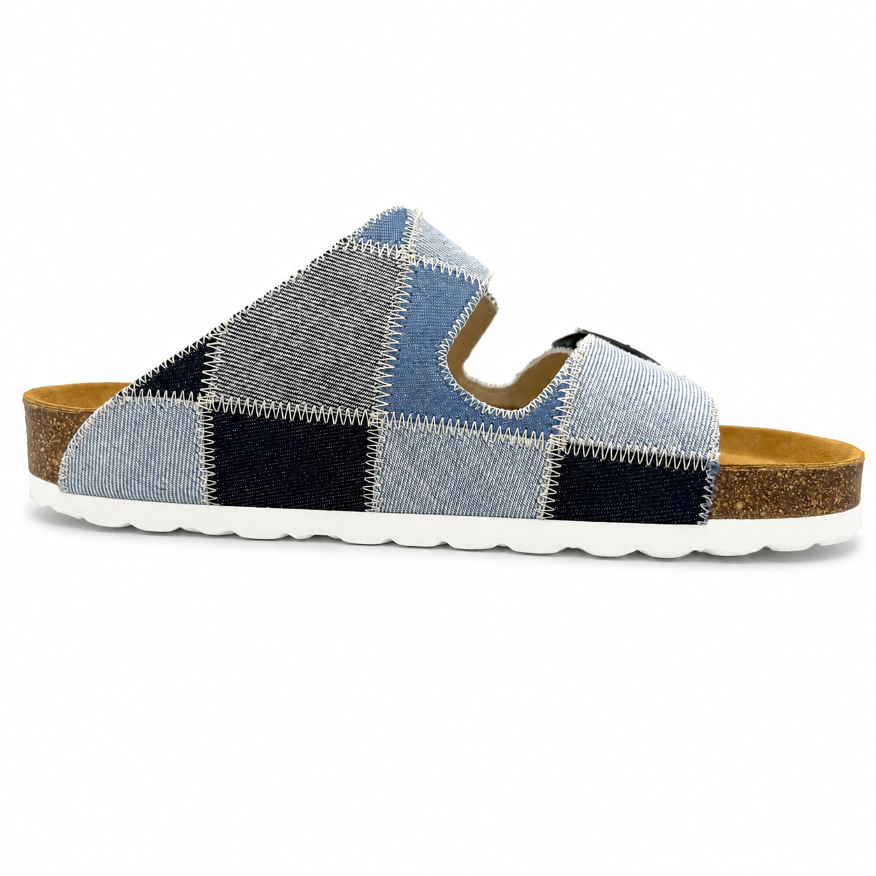 Pair of sandals with a geometric pattern worn with white socks on a plain background