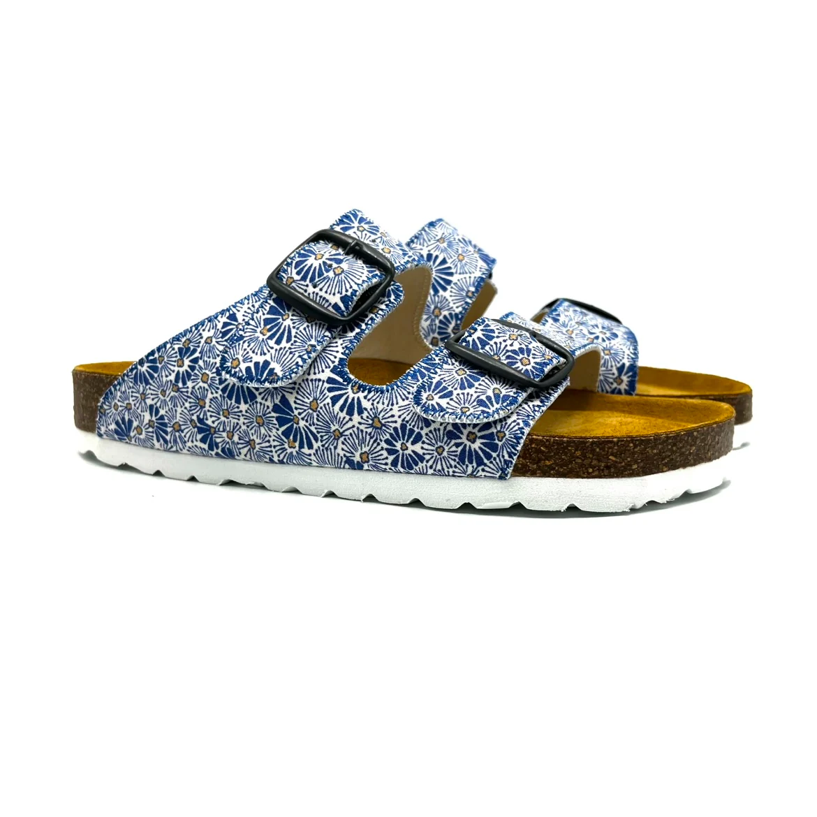 Pair of blue floral sandals with brown soles on a white background