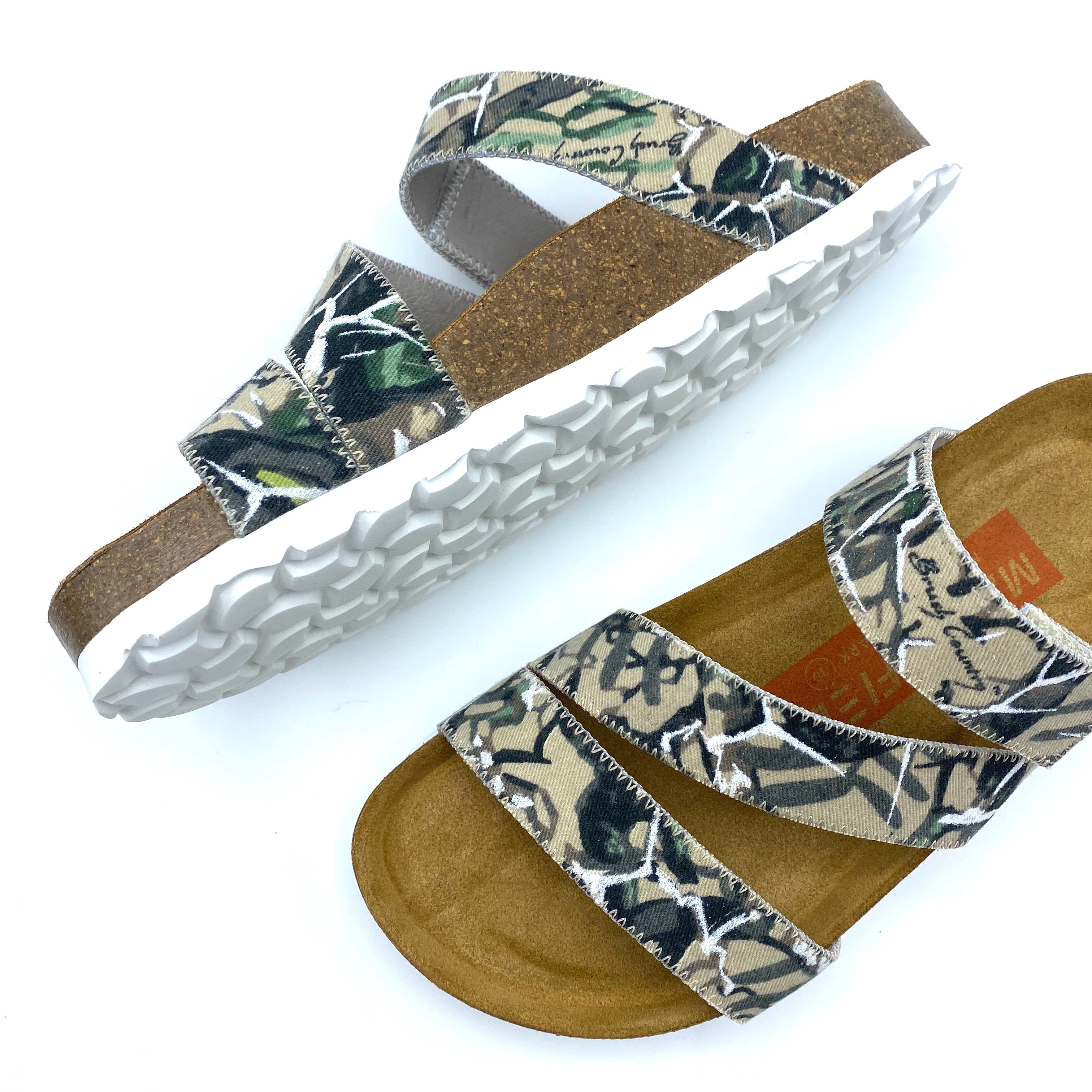 Pair of sandals with floral pattern on a white background
