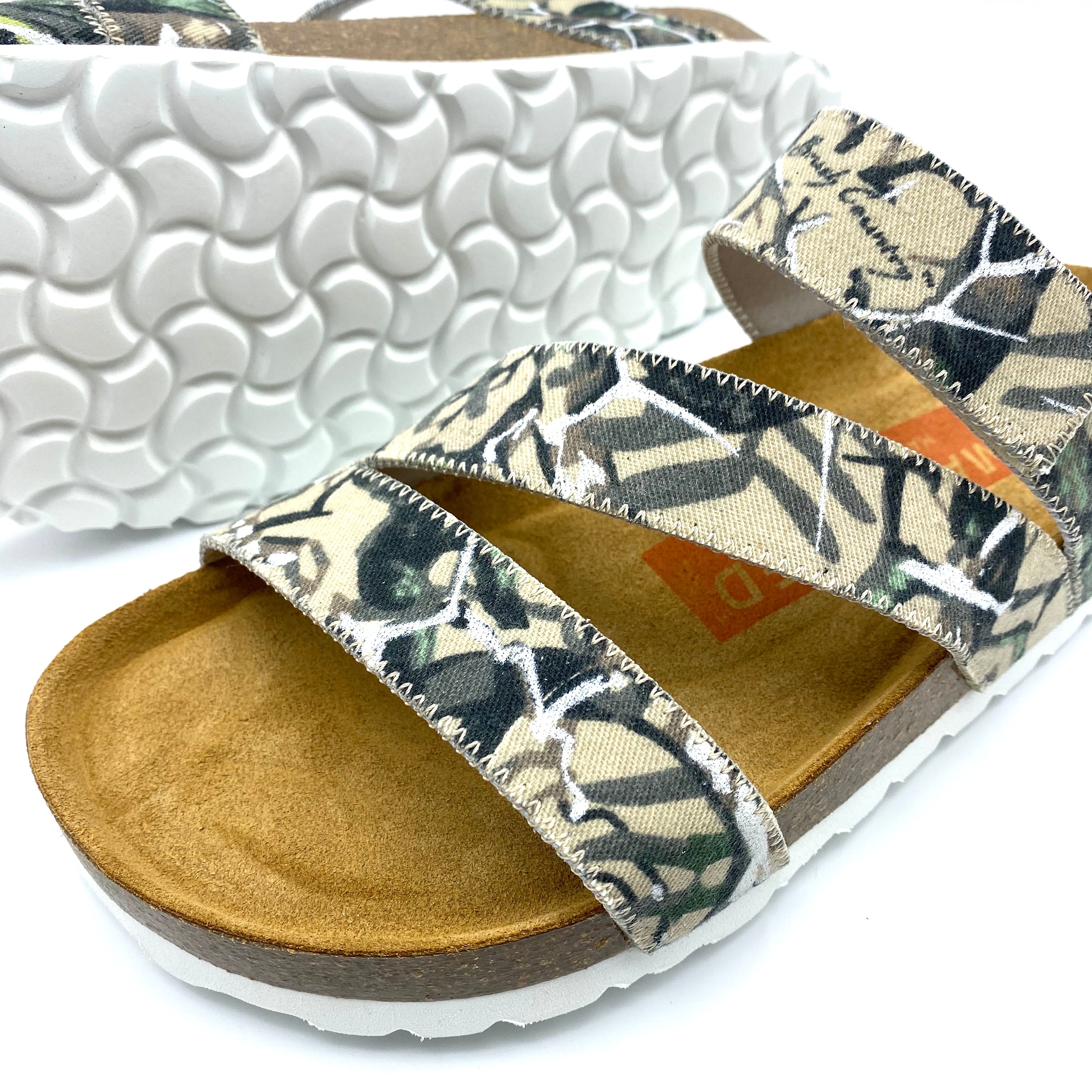 Pair of sandals with floral pattern on a white background